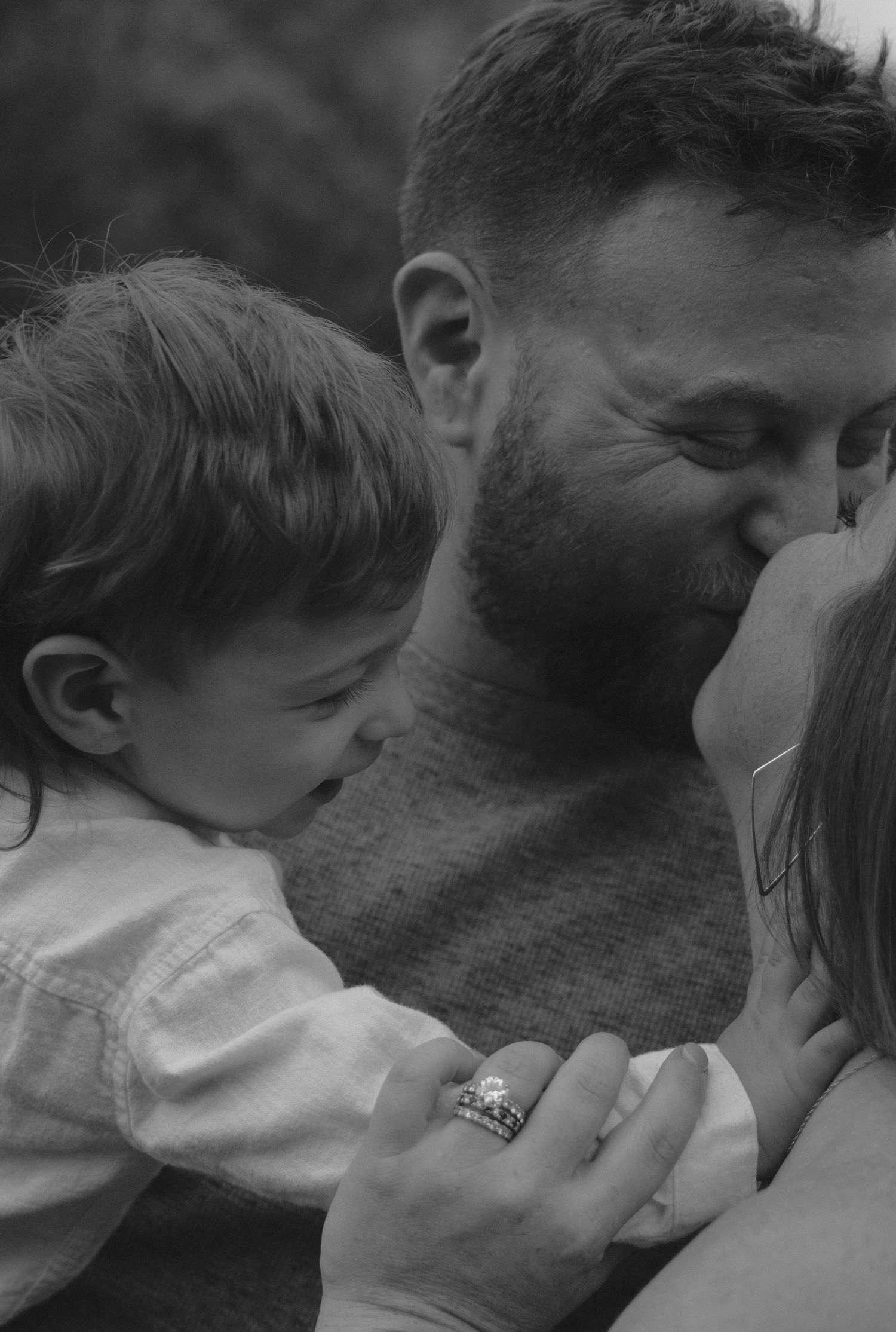 A black and white sequence of five intimate close-up shots showing tender kisses between two people.