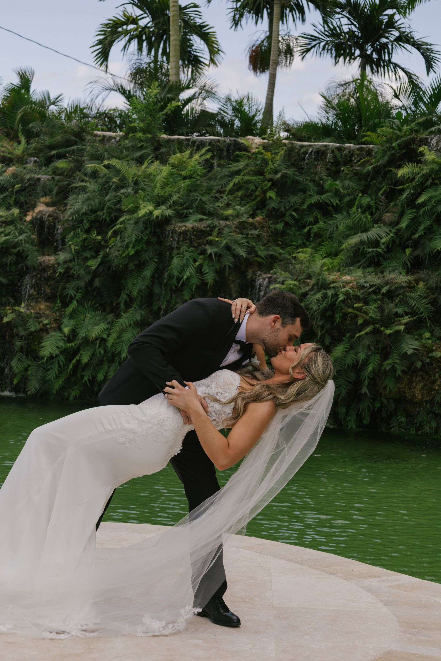 A romantic wedding photo sequence shows a couple in a dip pose against lush tropical greenery and water.
