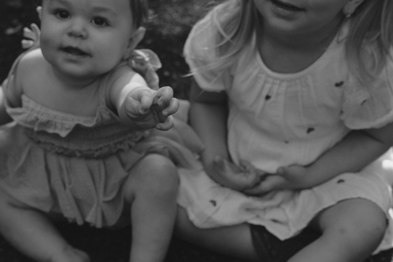 A black and white strip of photo booth portraits showing playful expressions and poses.