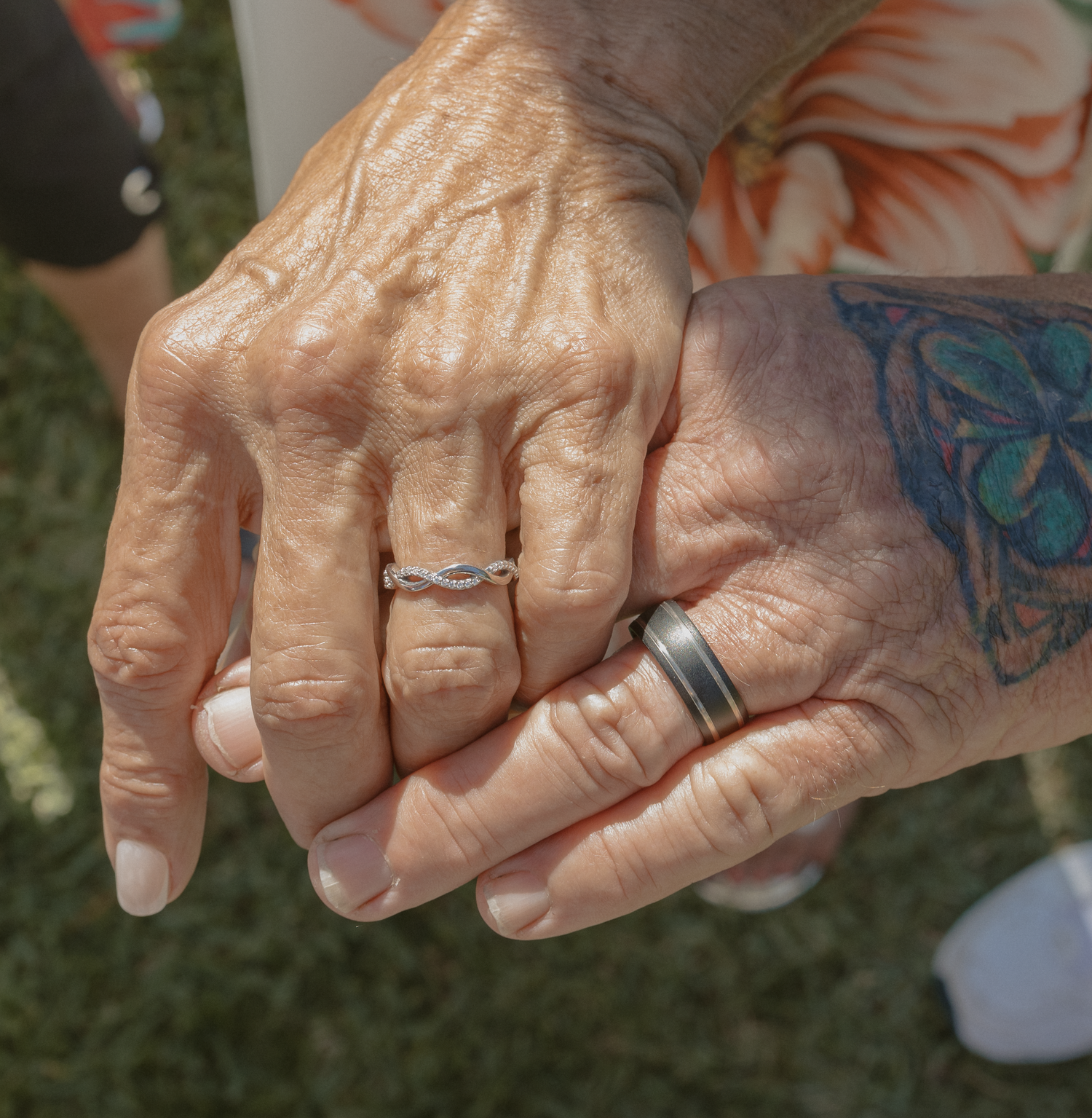 Close-up sequence showing hands with aged skin and silver rings against a blurred natural background.