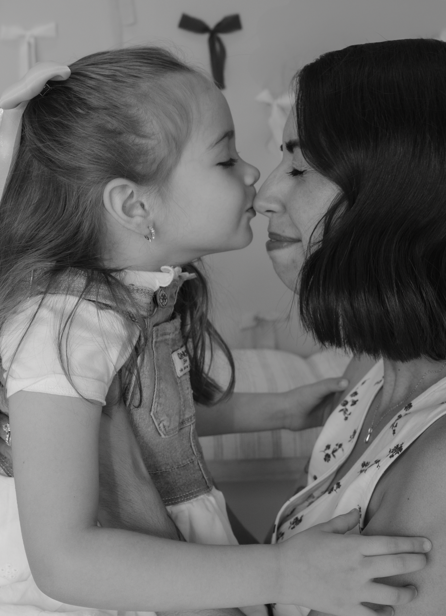 A series of black and white photos showing tender moments between two people in close proximity.