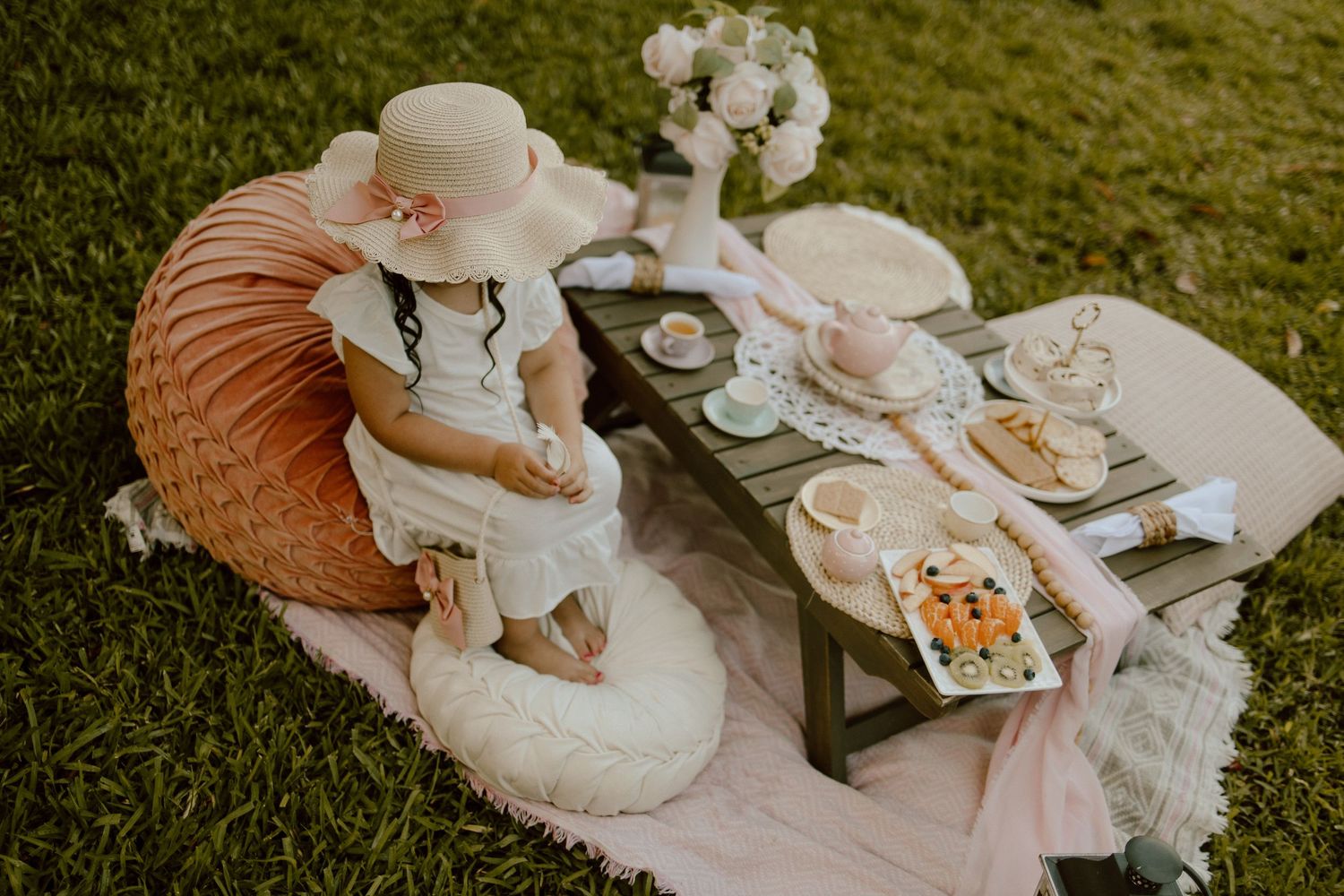 Charming garden tea party setup featuring floral arrangements and vintage-inspired decor.