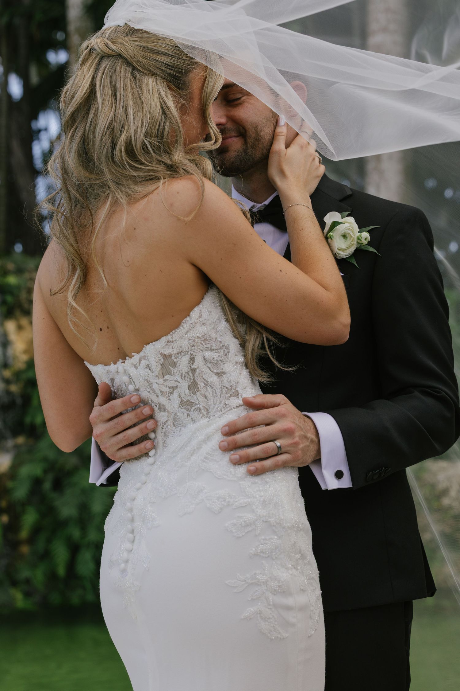 A romantic wedding moment captured in a series of photos showing a couple embracing under a veil in an outdoor garden setting.