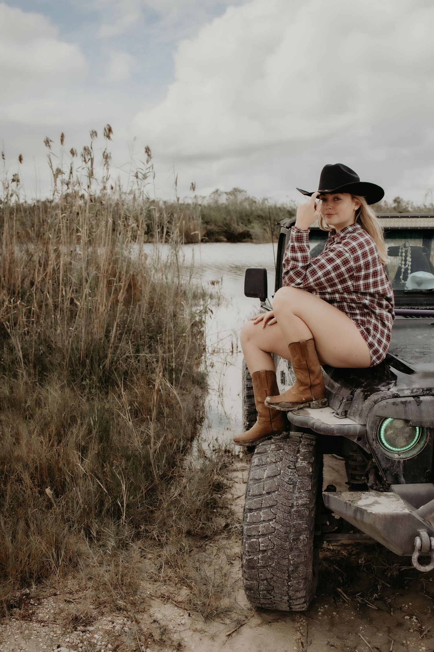 A series of four rustic outdoor photos showing someone sitting on a large tire wearing a plaid shirt and cowboy hat.