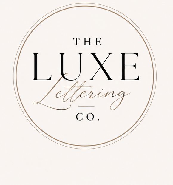 Elegant circular logo for The Luxe Lettering Co. featuring serif and script fonts in black and gold on a cream background.