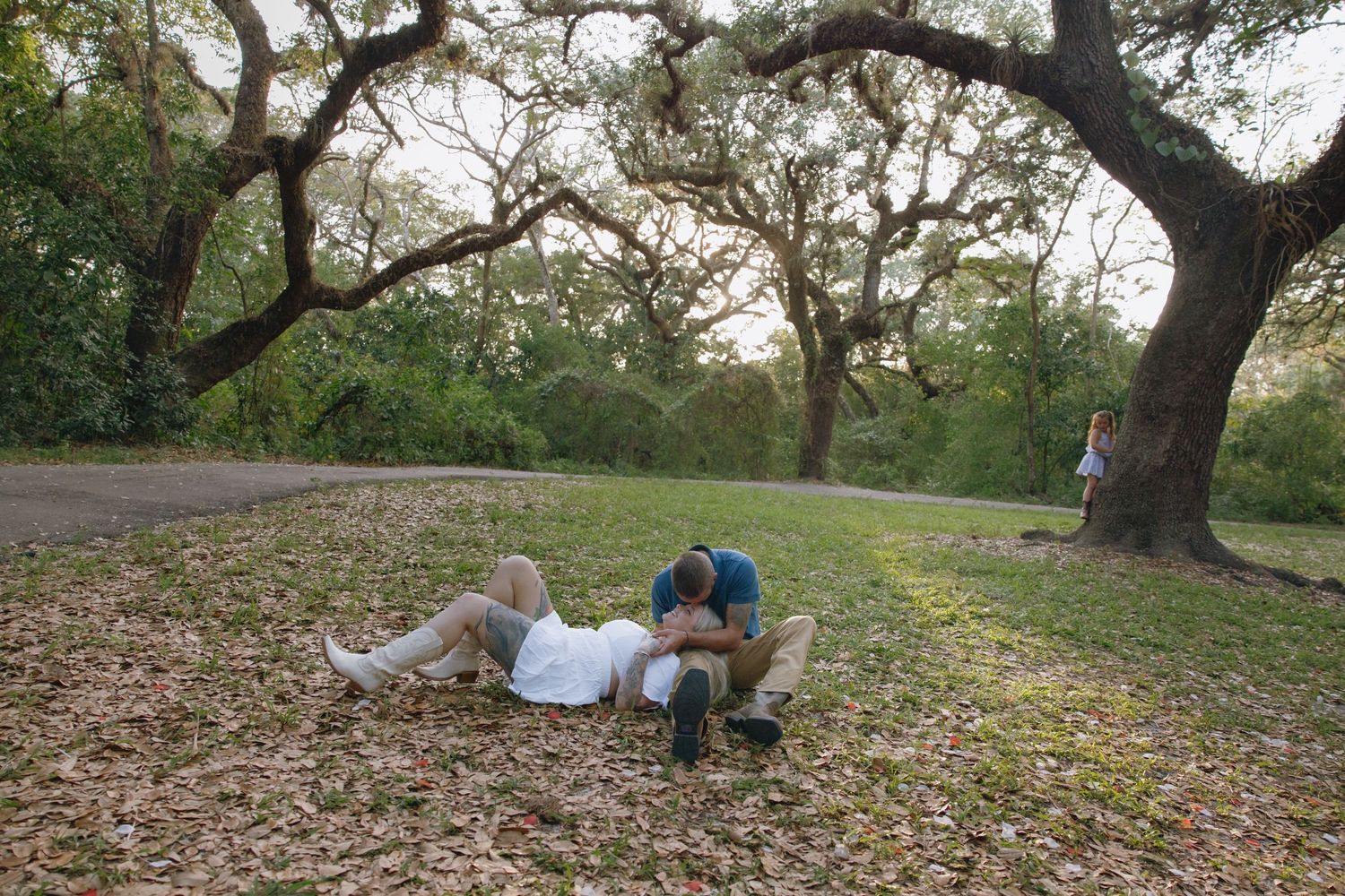 Series of romantic photos showing a couple enjoying time together under oak trees.