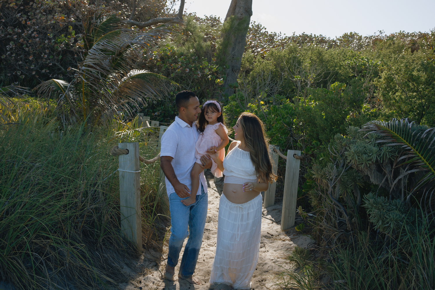 Natural pathway through lush coastal vegetation leading to the beach.