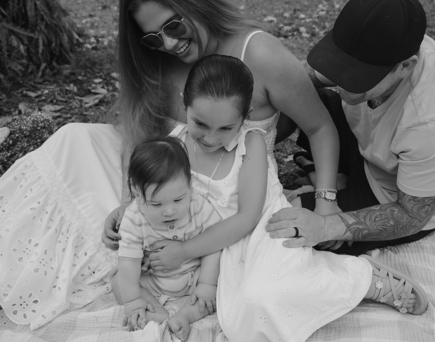 Black and white captures of family bonding moments during outdoor session.
