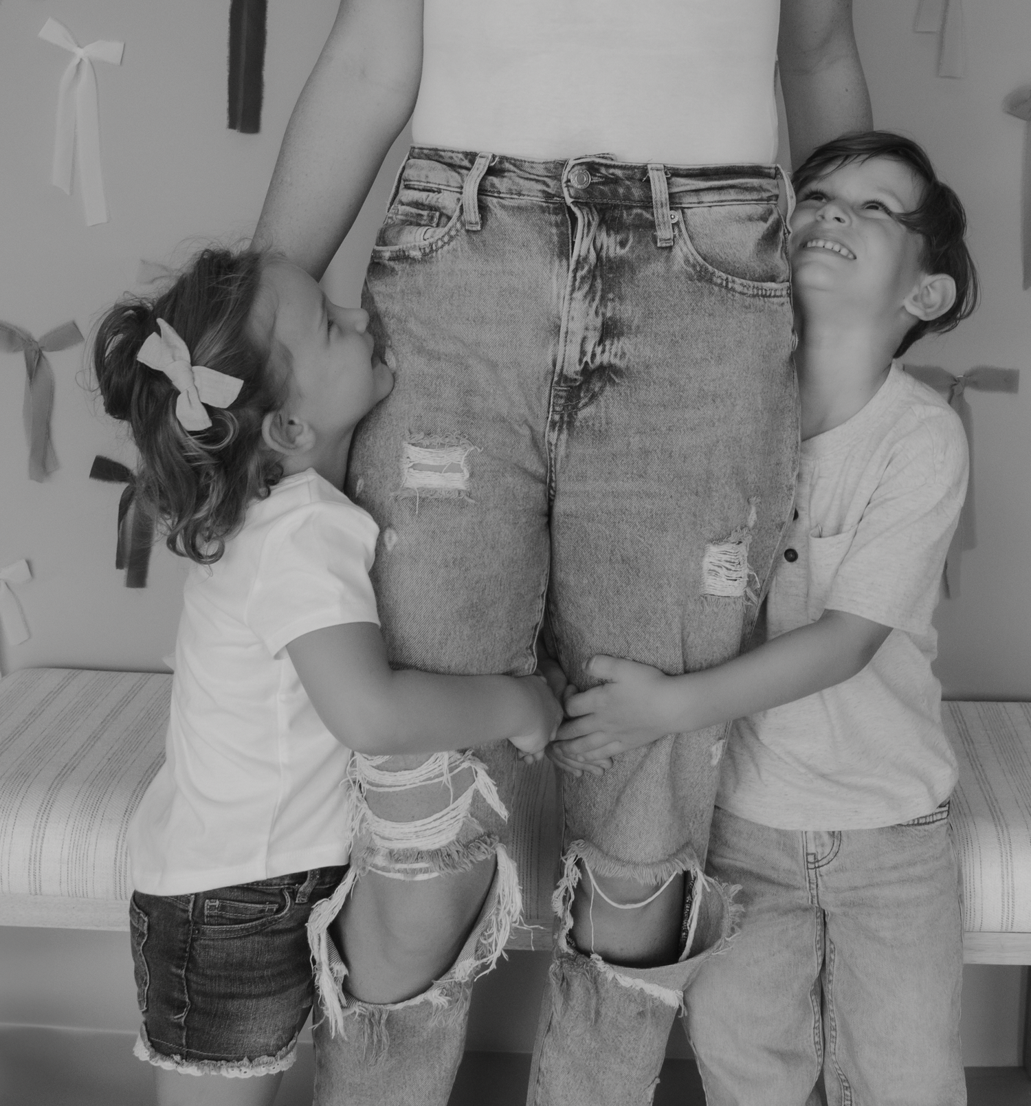 A black and white series showing people wearing casual denim and white tops in candid poses.