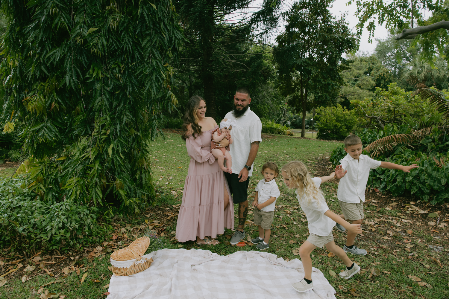 A group enjoys a candid moment together in a lush garden setting during a special outdoor celebration.