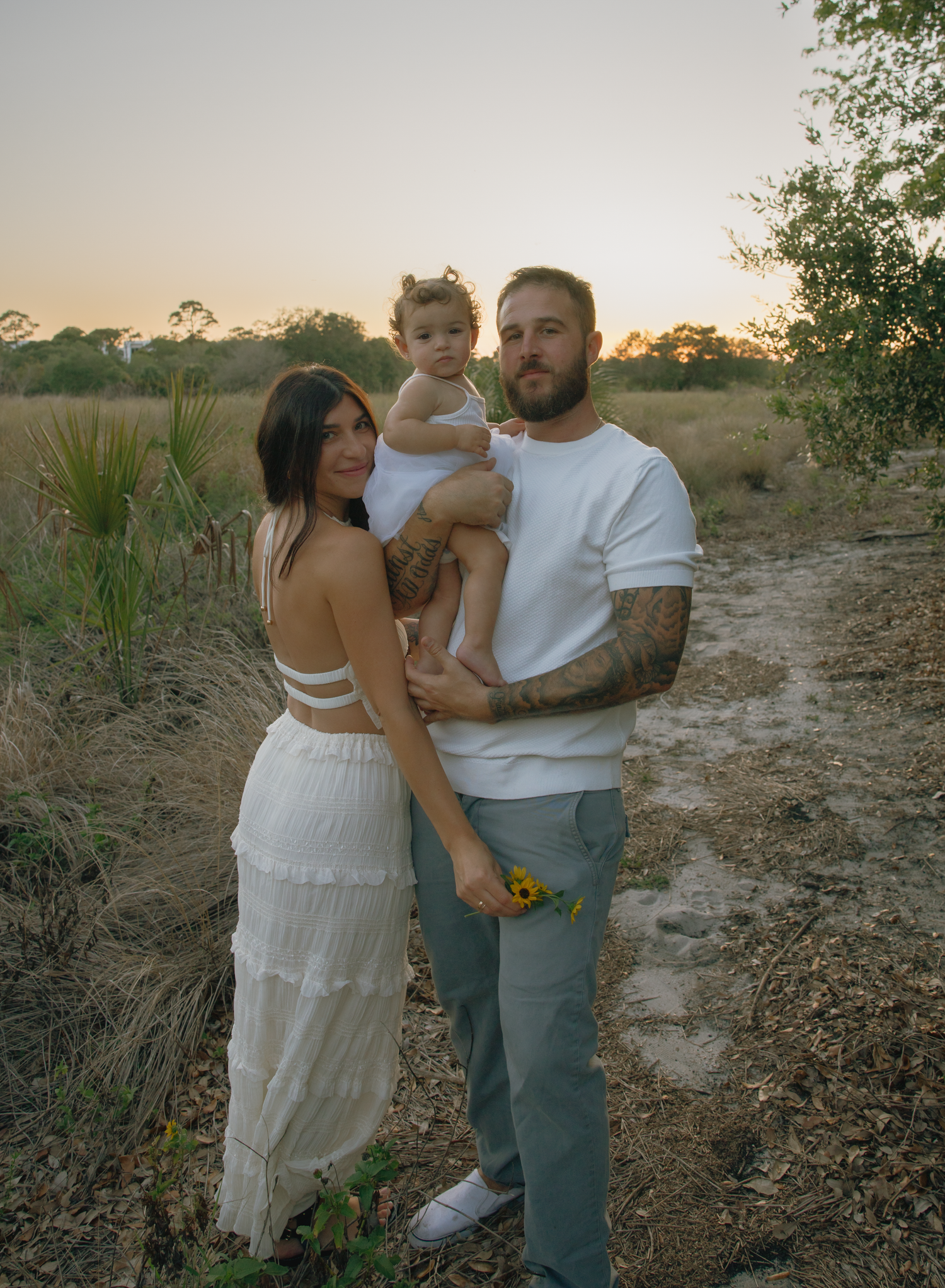 Intimate family portrait session in natural setting during golden hour.