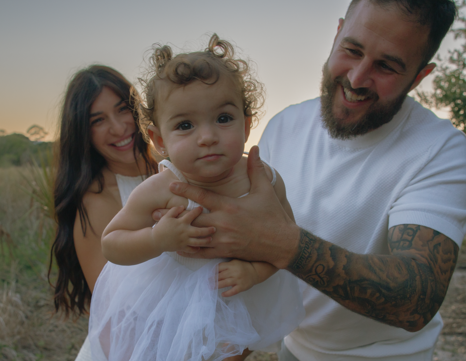 Tender family moments photographed in natural outdoor setting.