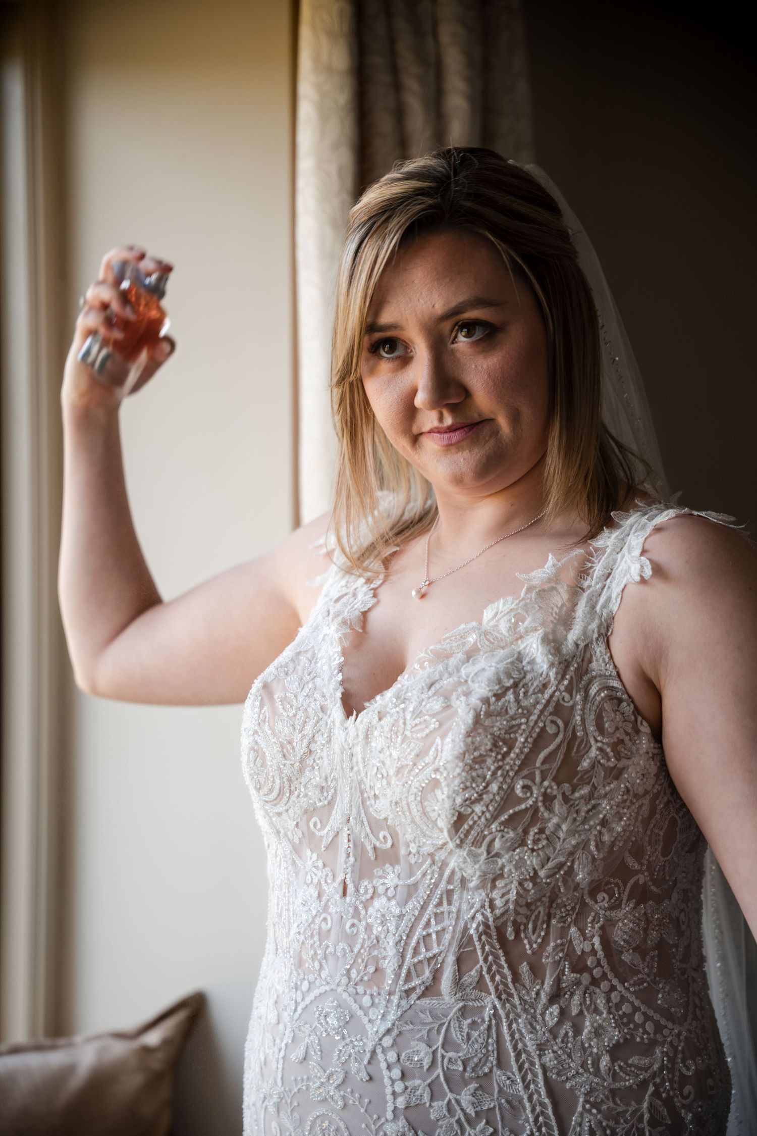 Elegant bridal portrait showcasing intricate lace wedding dress details near a window.
Cider mill barns wedding venue