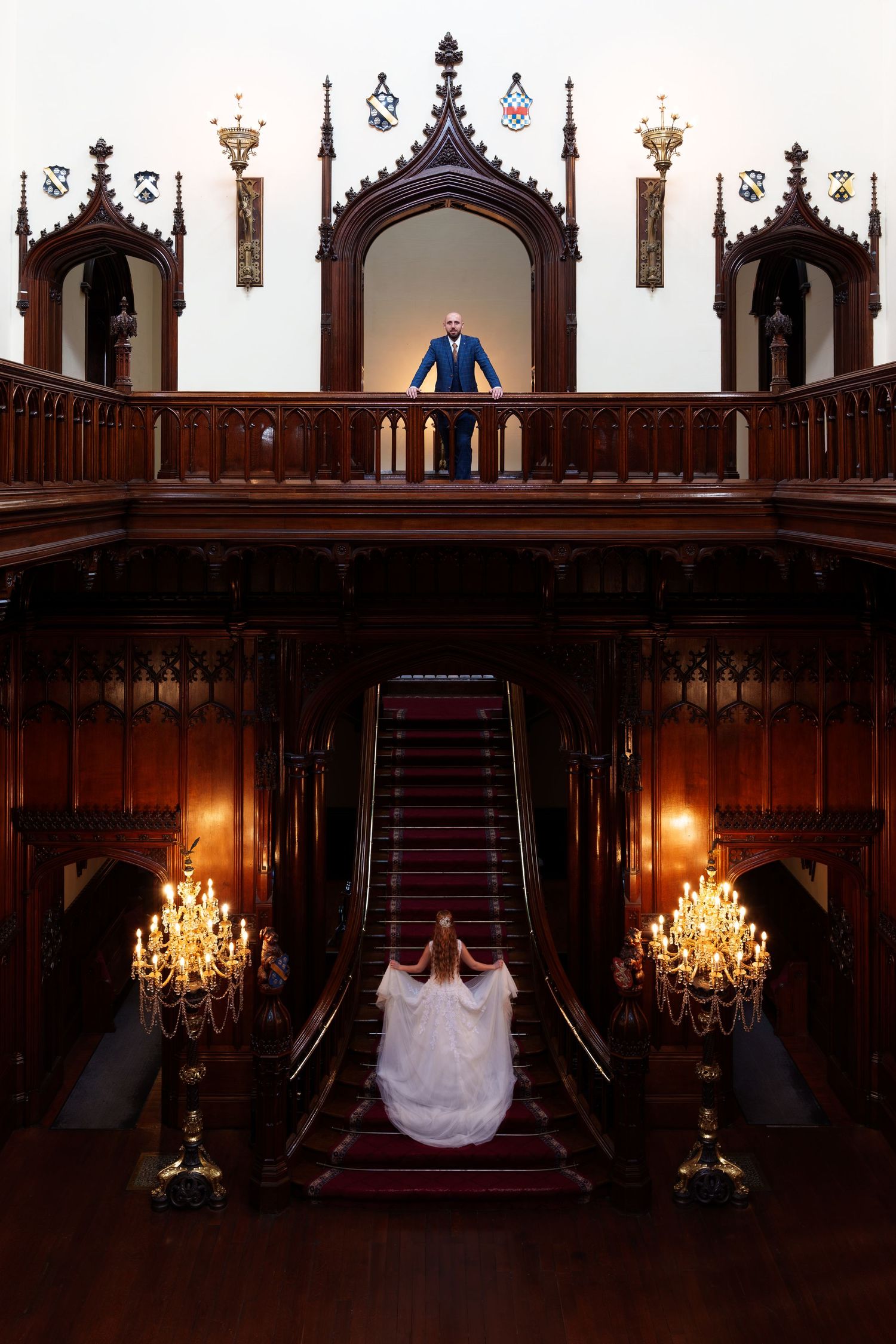 Elegant wedding photo series showing decorative stairs and chandelier in grand historic mansion interior.