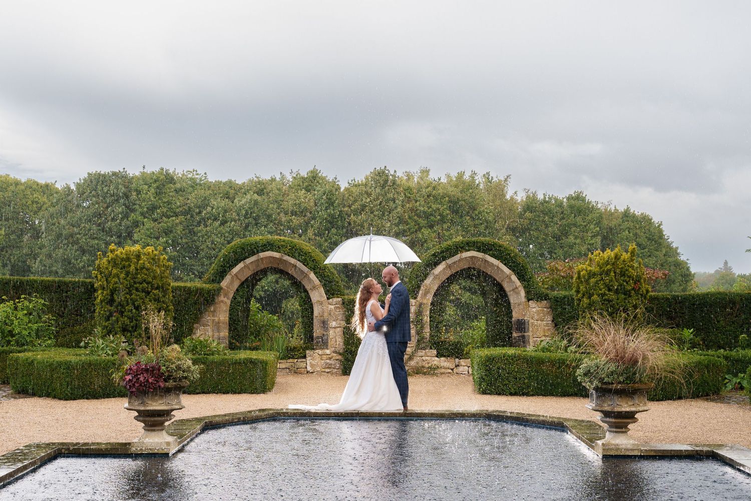 A series of wedding celebration photos showing a large garden arch over a reflecting pond with lush greenery.