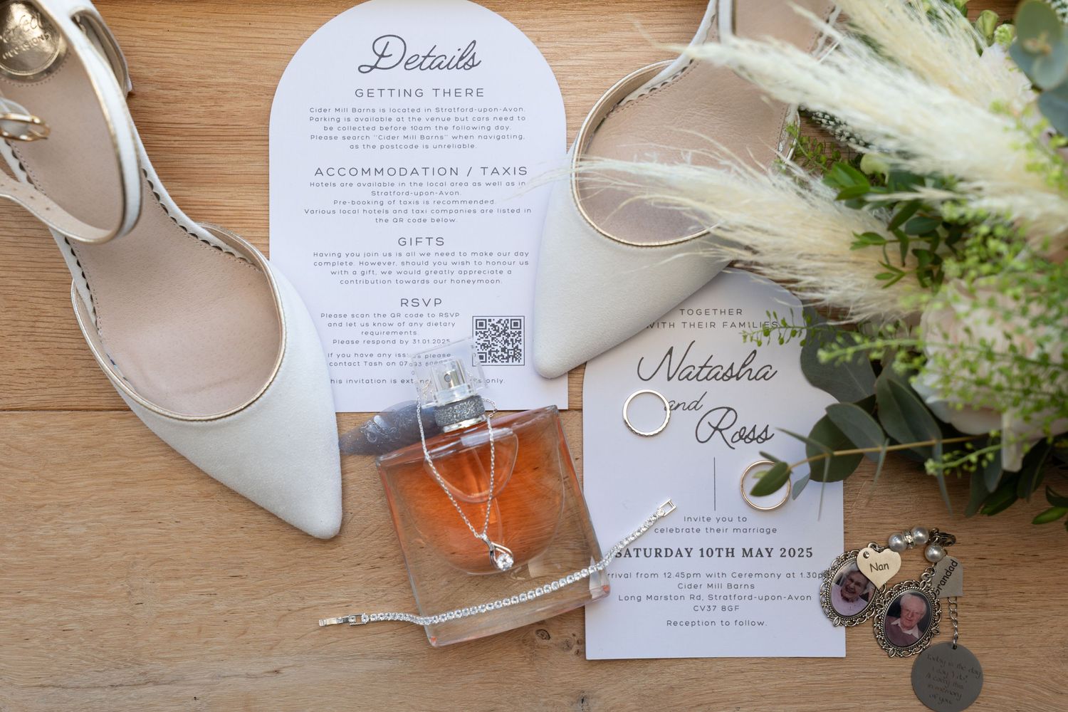 Wedding details flatlay with white shoes, invitation cards, and fresh flowers on wooden surface.
Cider mill barns wedding venue