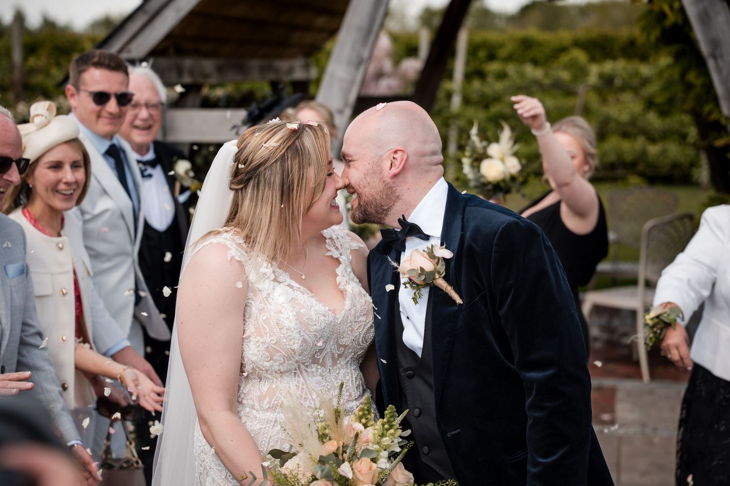 A joyful wedding celebration moment captured outdoors under natural lighting.