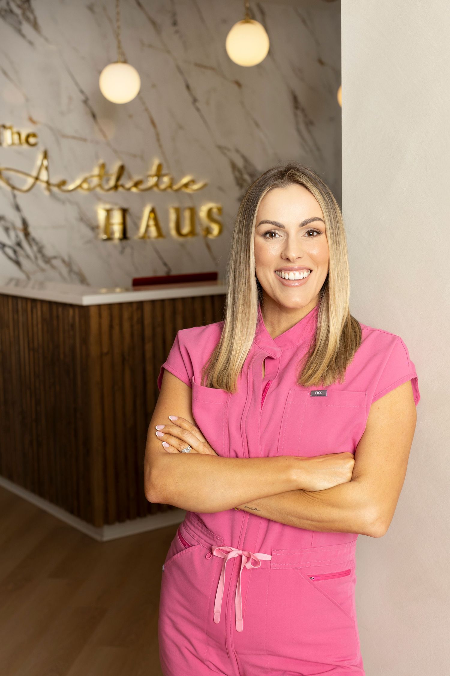 Person in bright pink professional attire stands. Business photos for business owners in Louisiana.