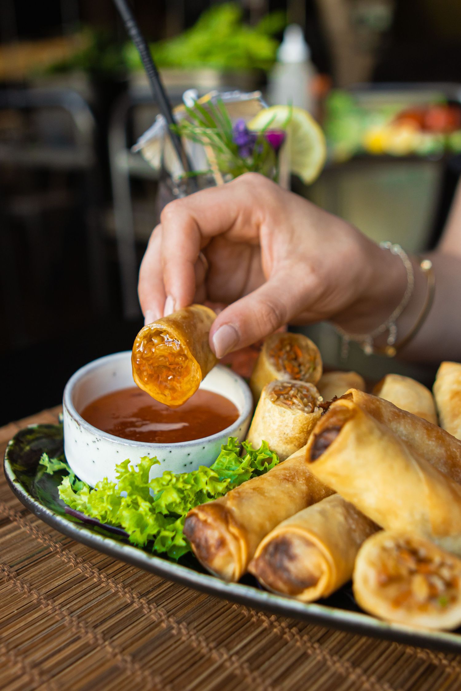 Spring rolls served on lettuce leaves with a dipping sauce.