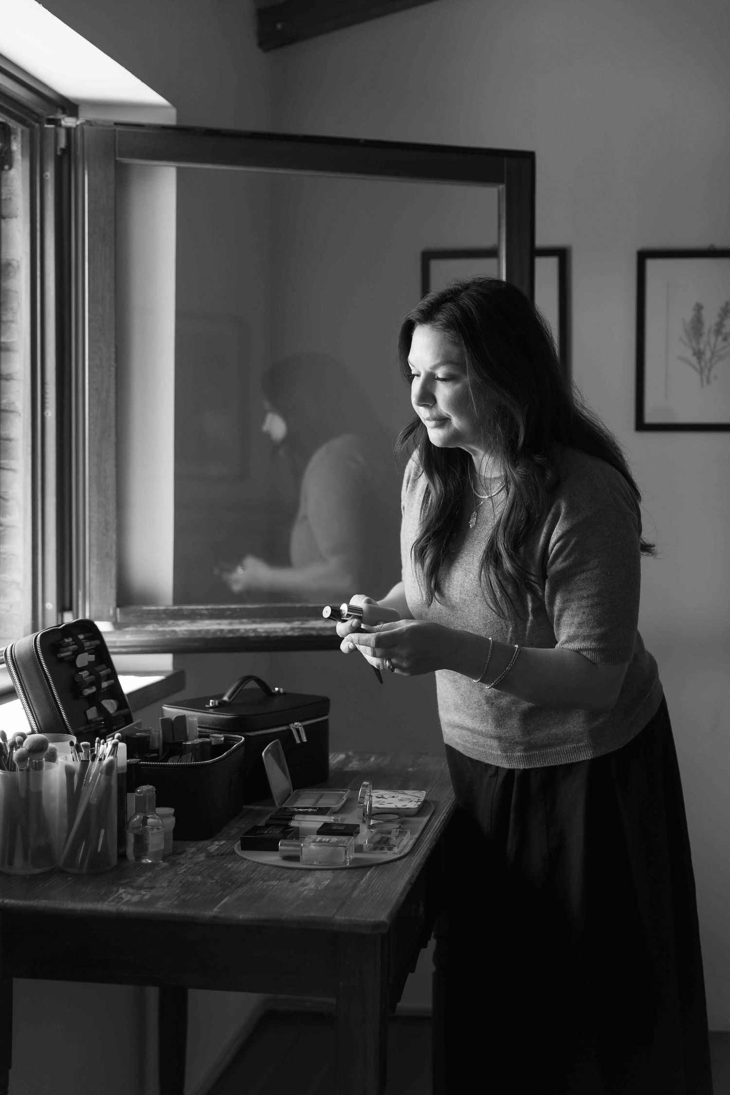 Black and white photos show preparations for a wedding day with someone working at a desk.