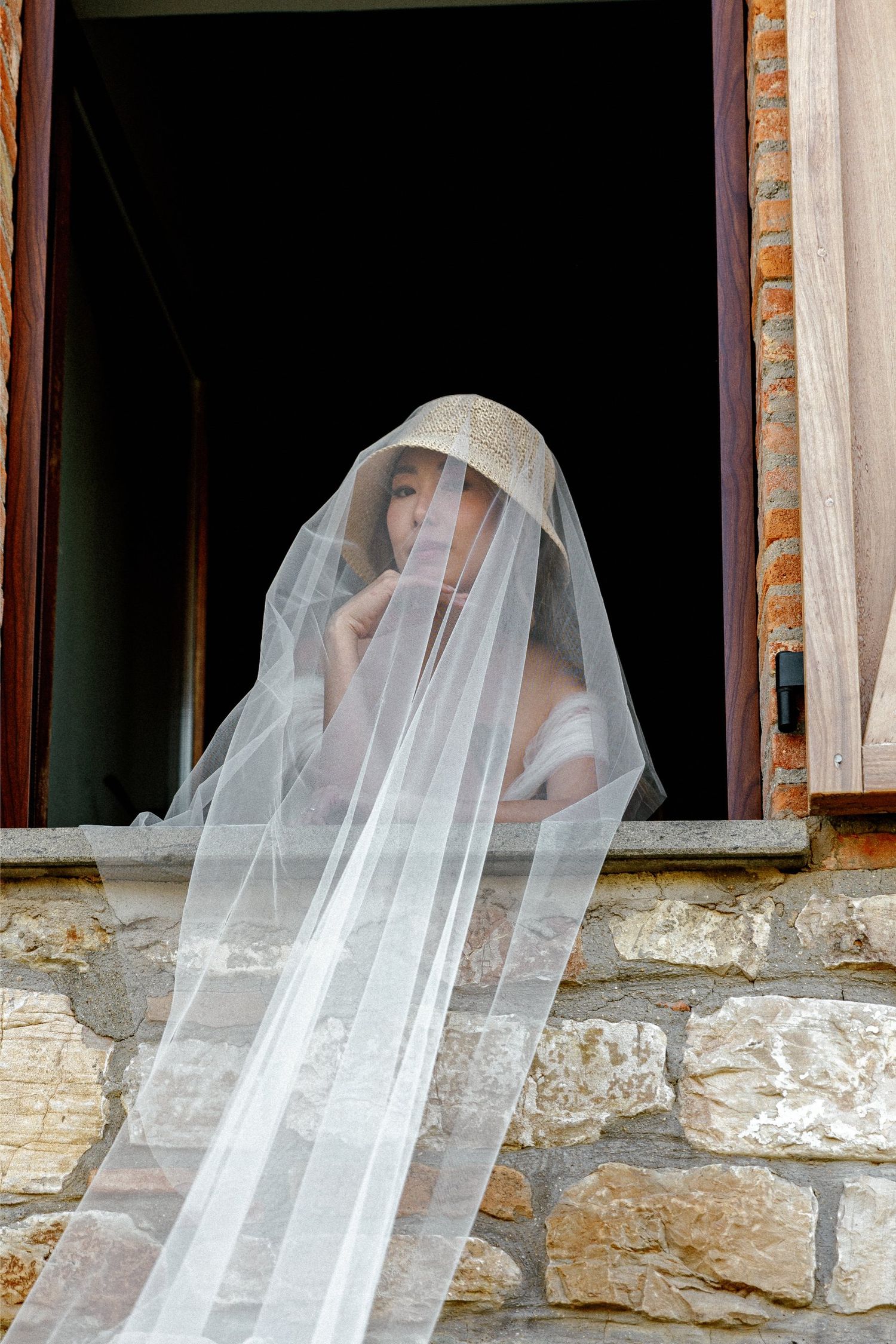 Ghostly white figures appear to float behind stone columns in an eerie architectural setting.