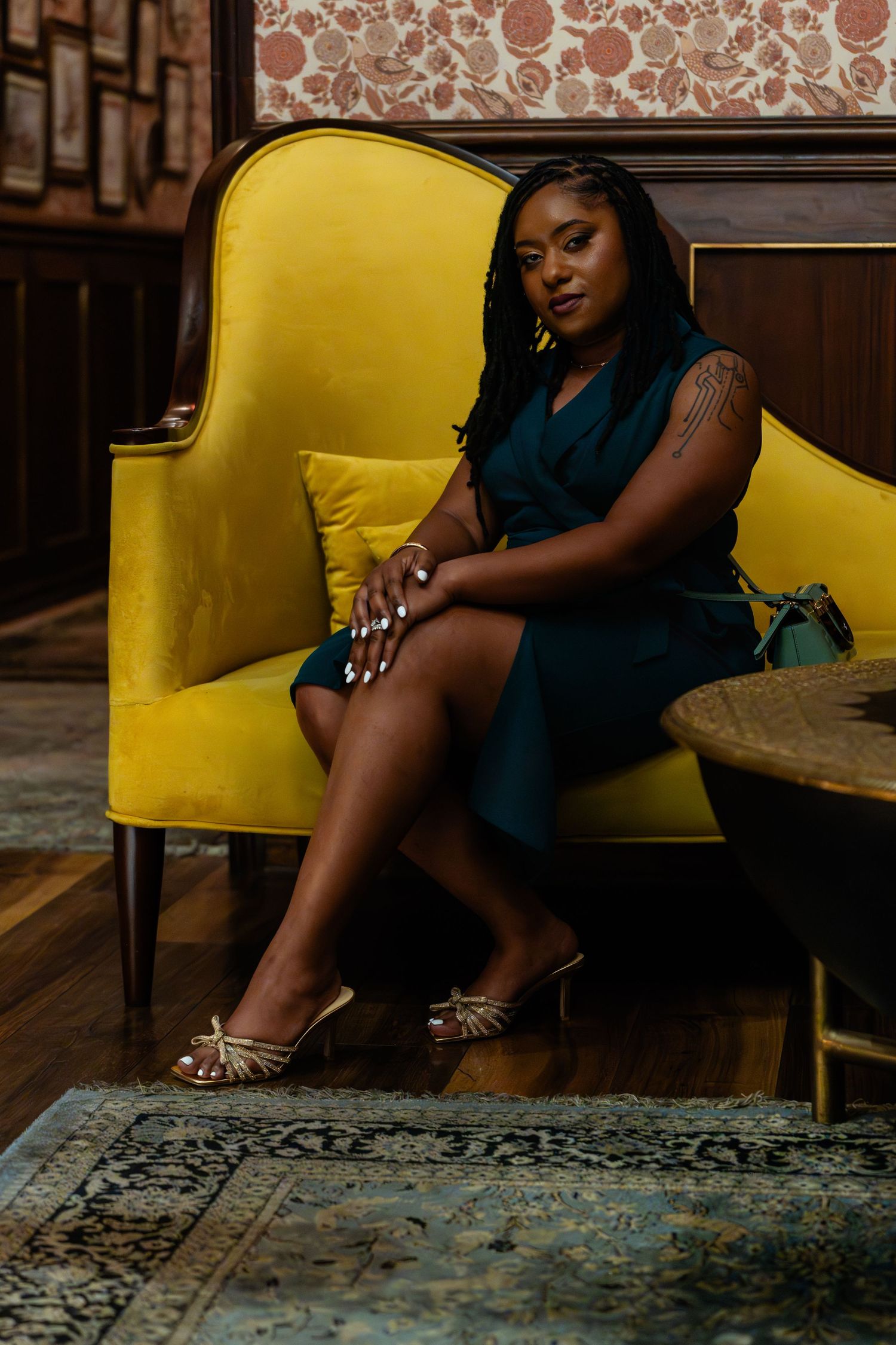 Artistic portrait series featuring poses on a yellow vintage chair against patterned wallpaper. Powerrpackmedia Houston Texas