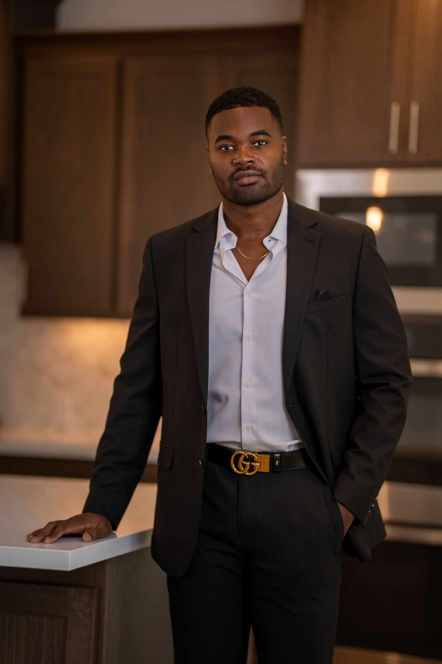 Professional business portraits in a modern kitchen setting wearing formal attire. Powerrpackmedia Houston Texas