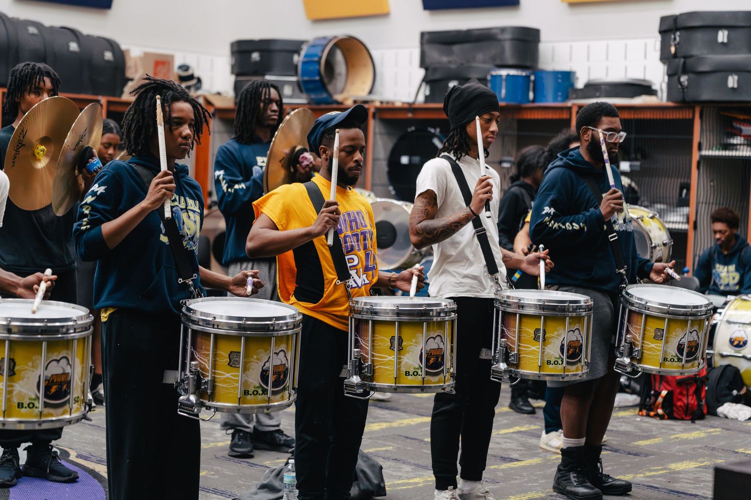 Marching band drummers perform in formation during an outdoor event. Powerrpackmedia Houston Texas