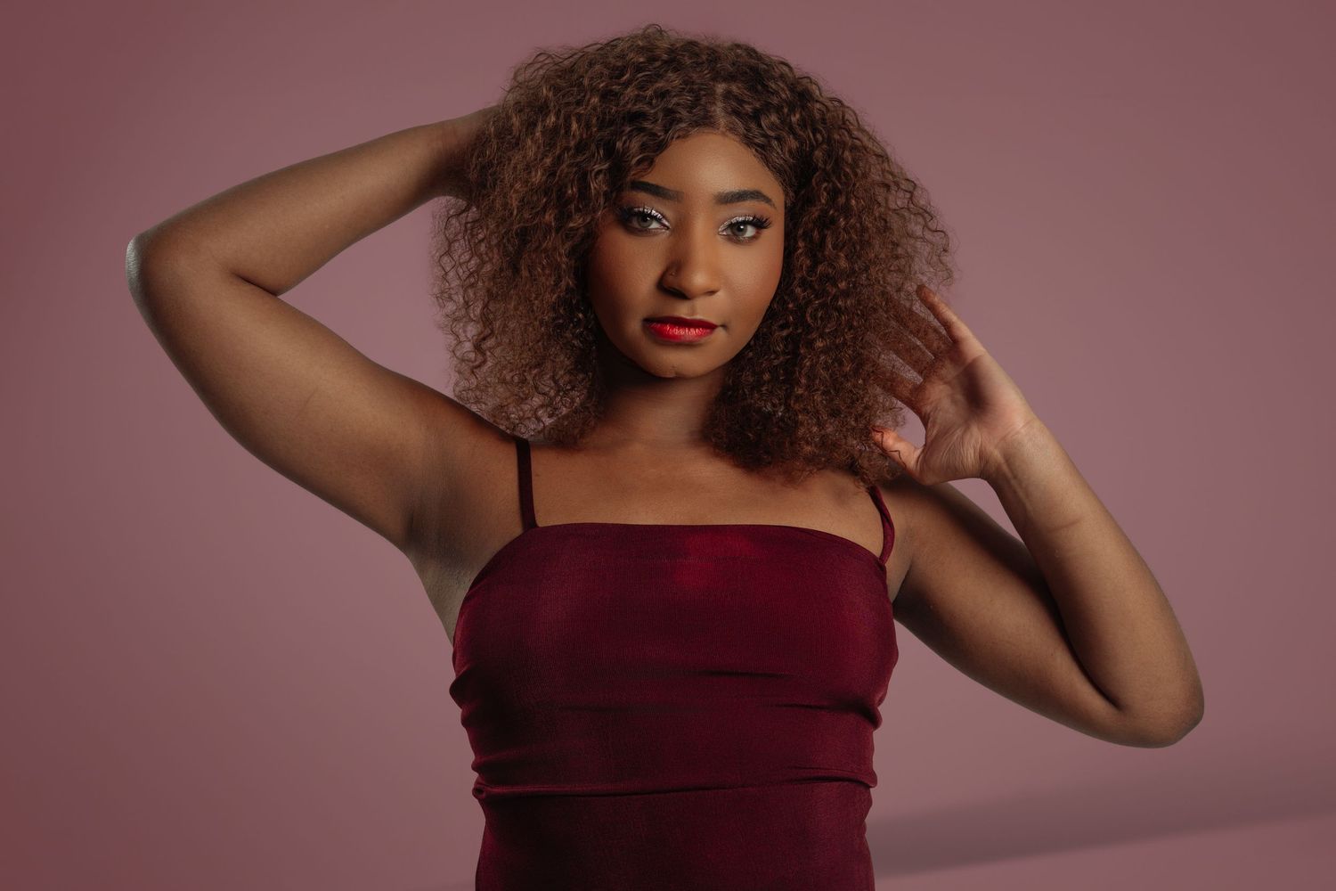 Portrait series showing natural curly hair against a burgundy background. Powerrpackmedia Houston Texas