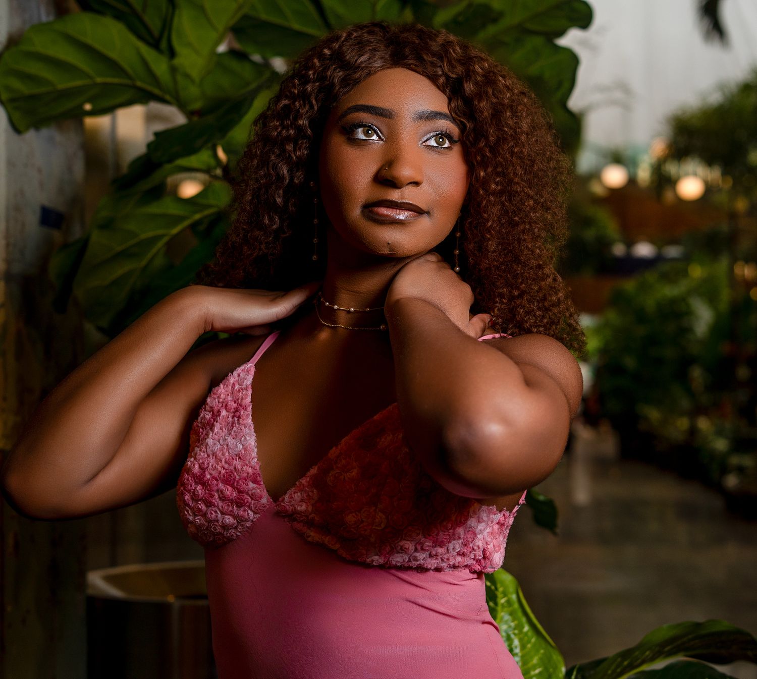 Artistic portraits in a garden setting featuring a pink outfit and curly hair. Powerrpackmedia Houston Texas