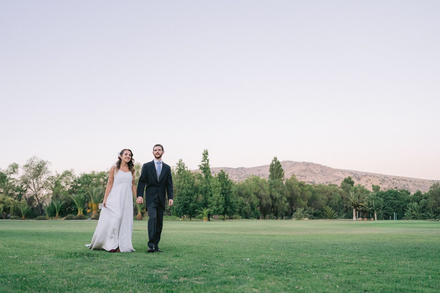 Scenic outdoor wedding ceremony setup with mountain views and natural landscape.