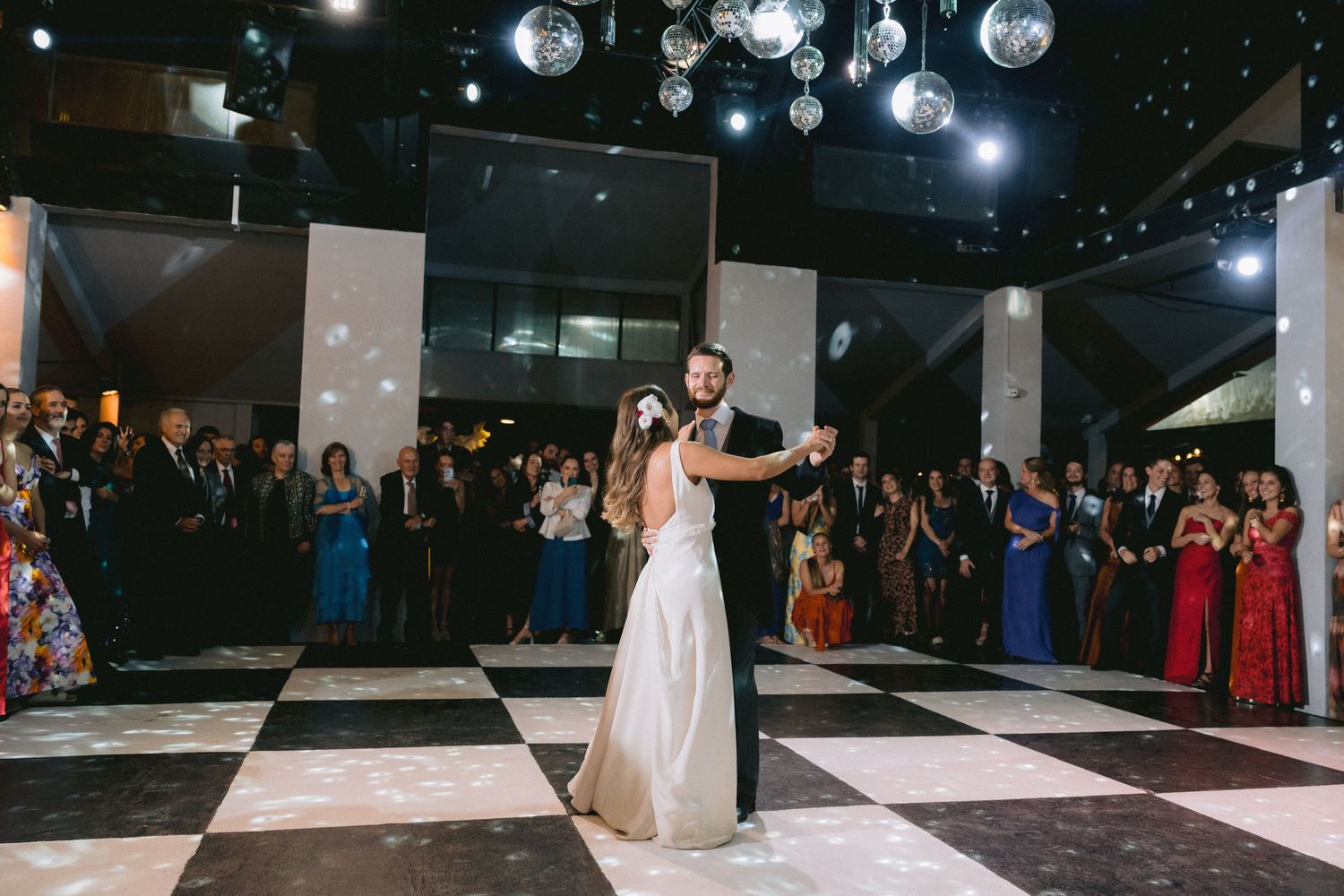 Wedding reception dance floor with disco balls and dramatic lighting.
