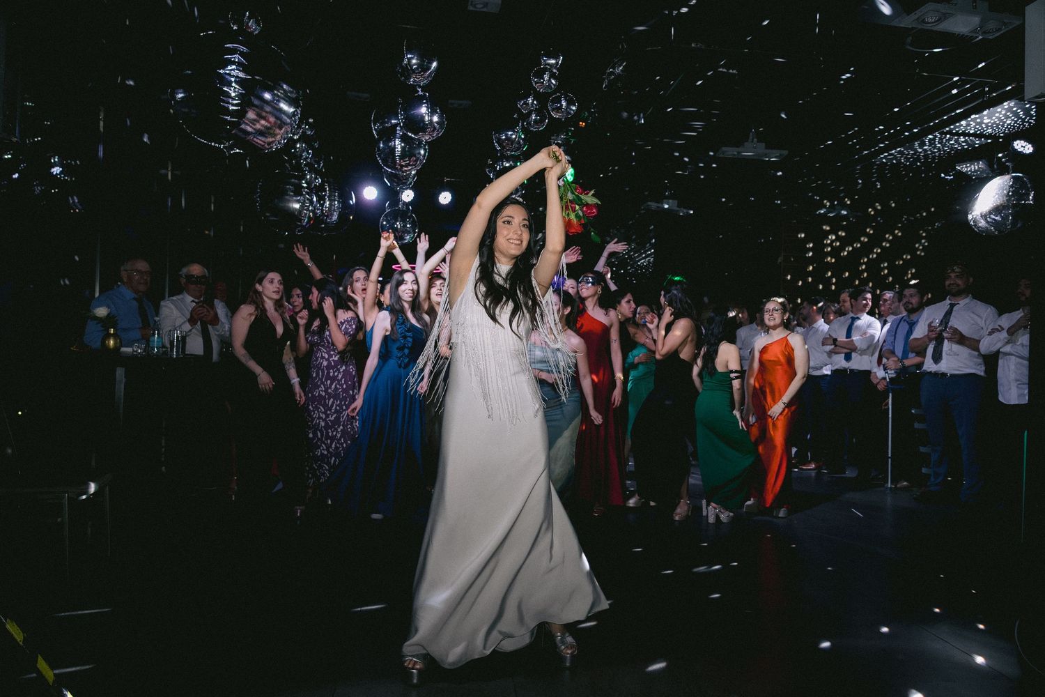 Wedding celebration at night with guests dancing and enjoying the festivities.