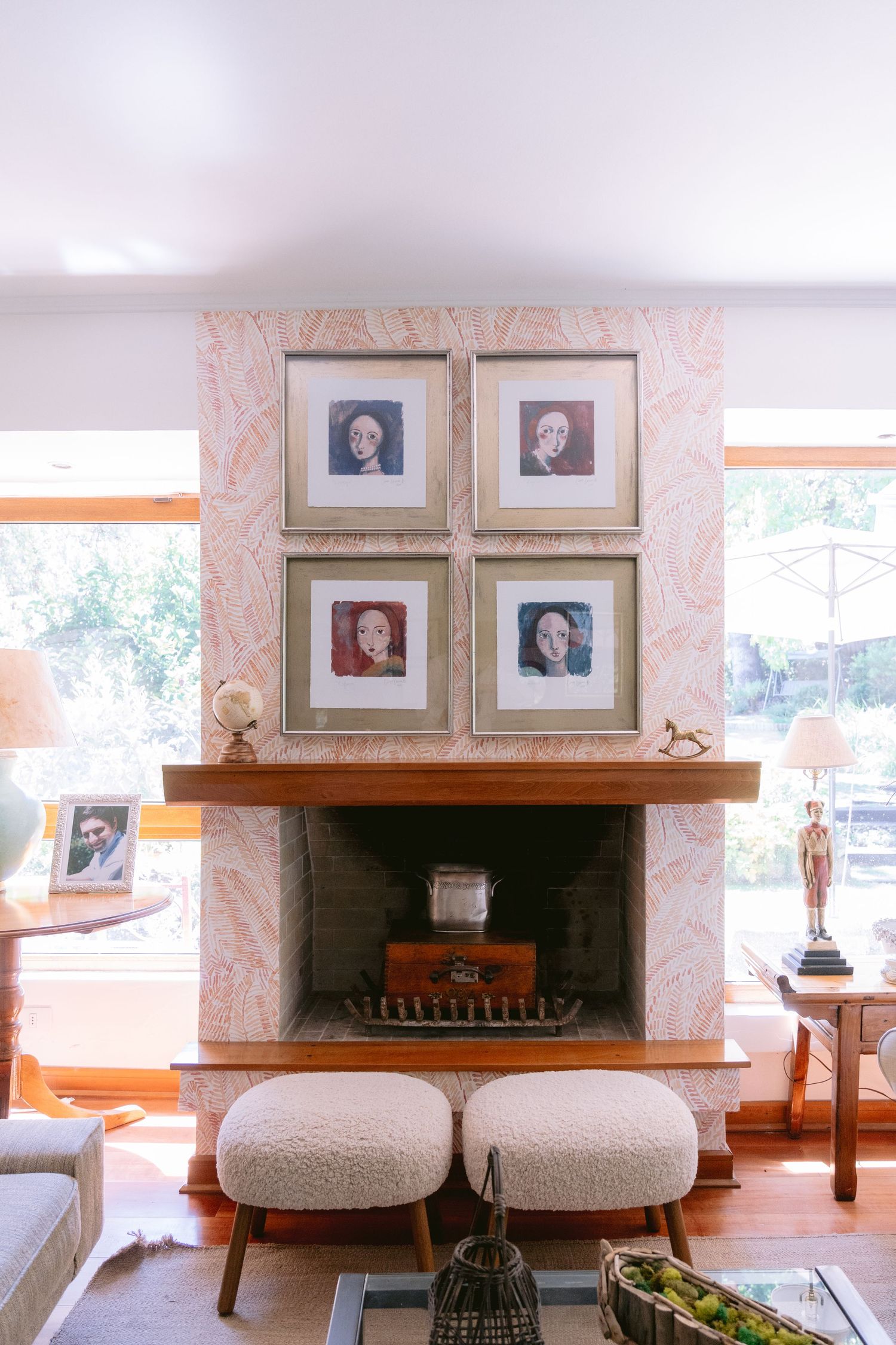 Elegant living room interior with framed portraits and comfortable seating.