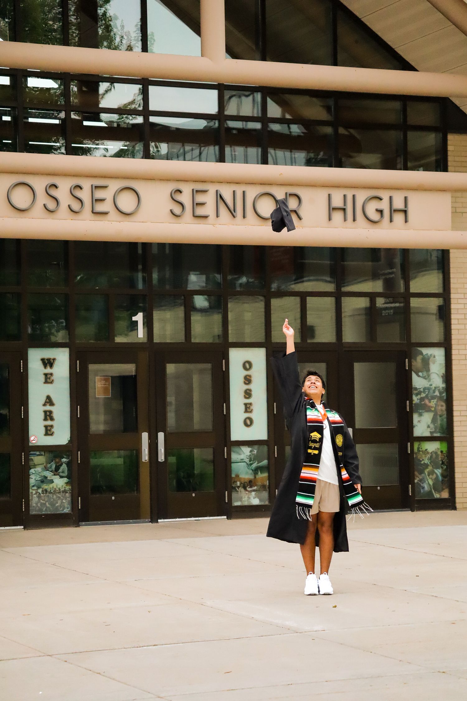 High school graduation portrait. School front.