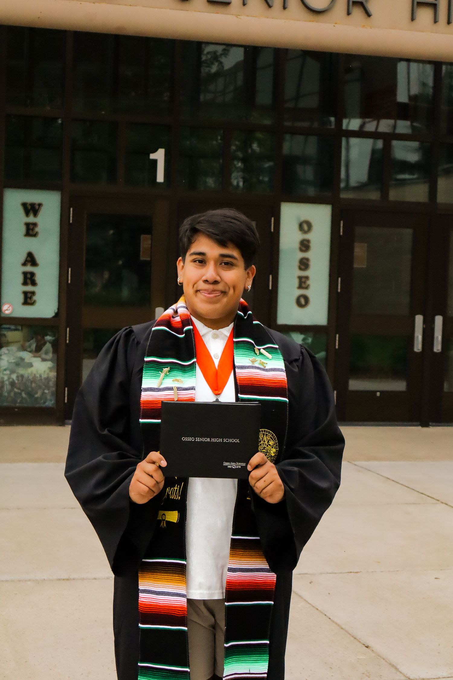 High school graduation portrait. School front.