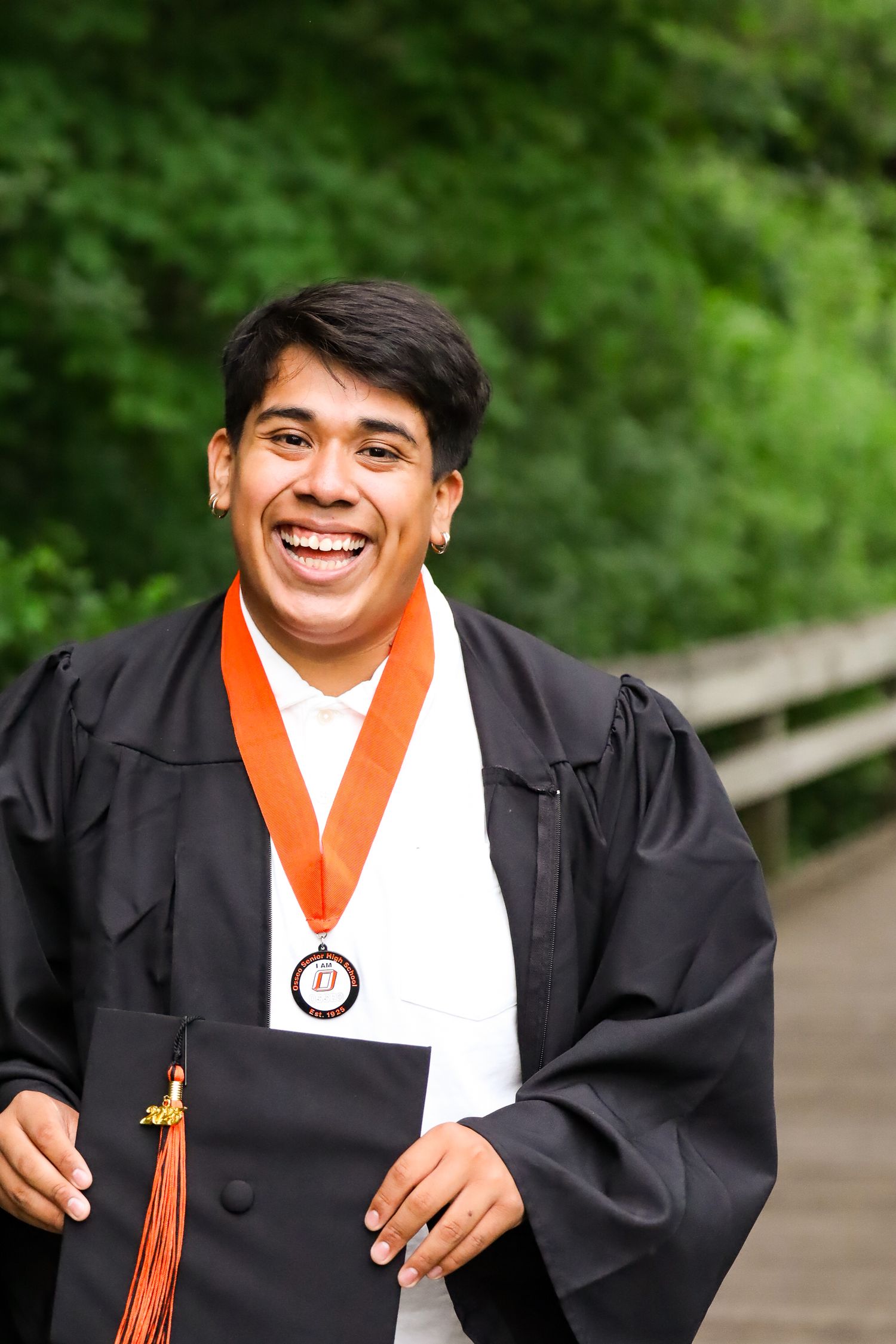 High school graduation portrait. Garden, park.
