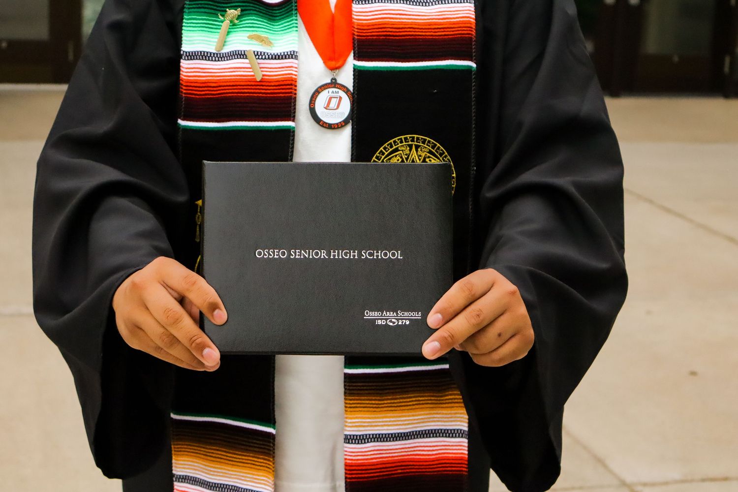 High school graduation portrait. School front.