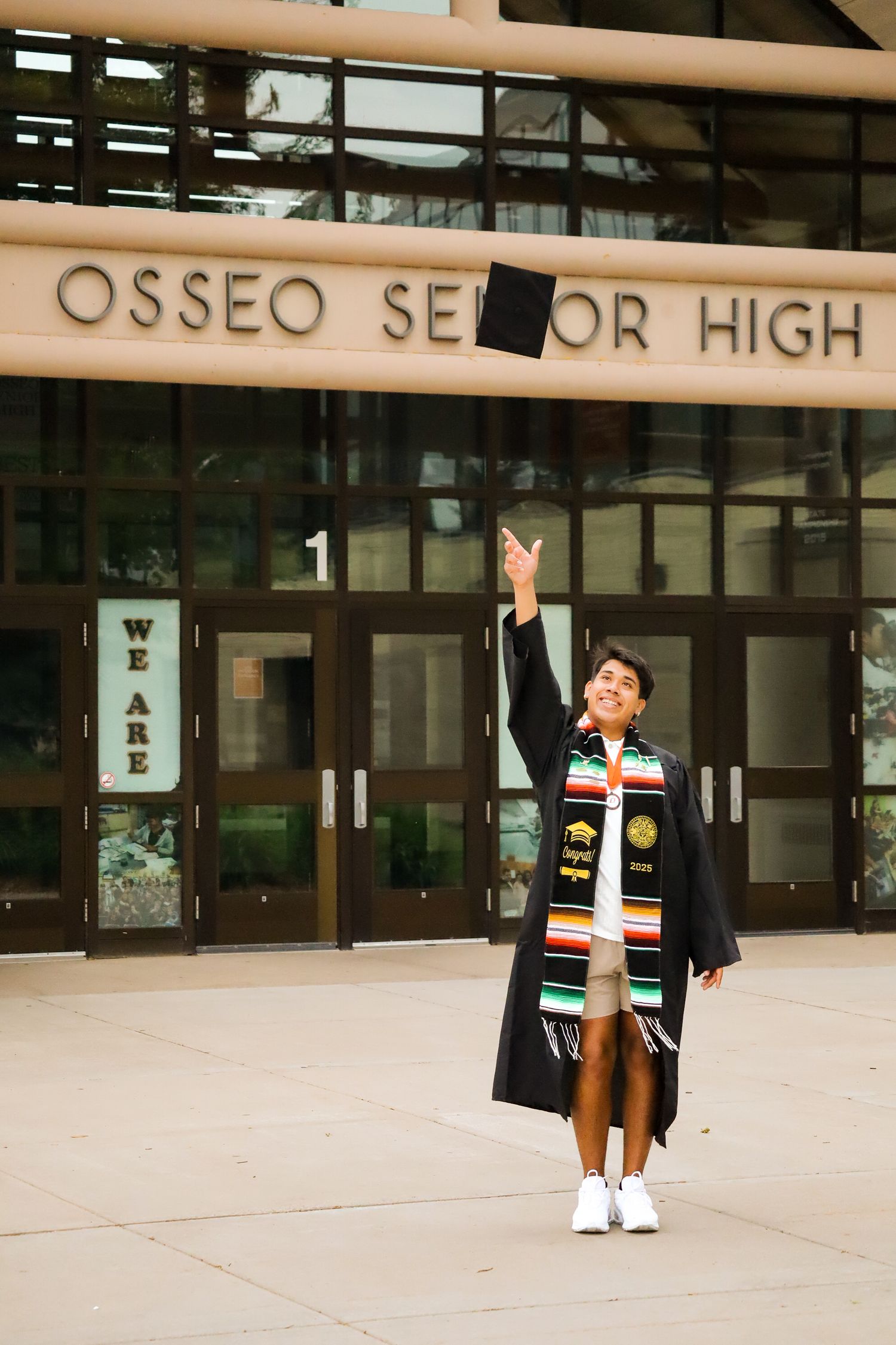 High school graduation portrait. School front.