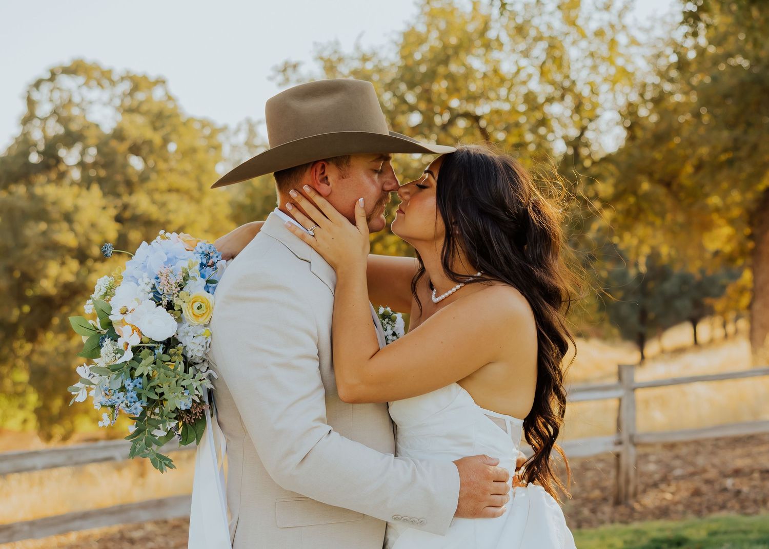 Intimate wedding portraits captured in warm sunset light under oak trees.