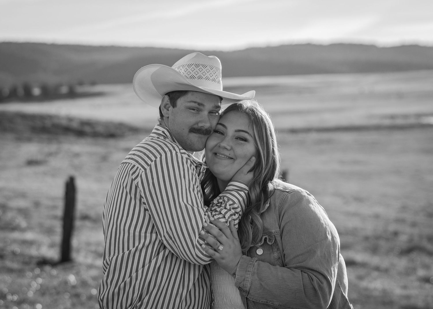 A romantic countryside photoshoot with rolling hills in the background.
