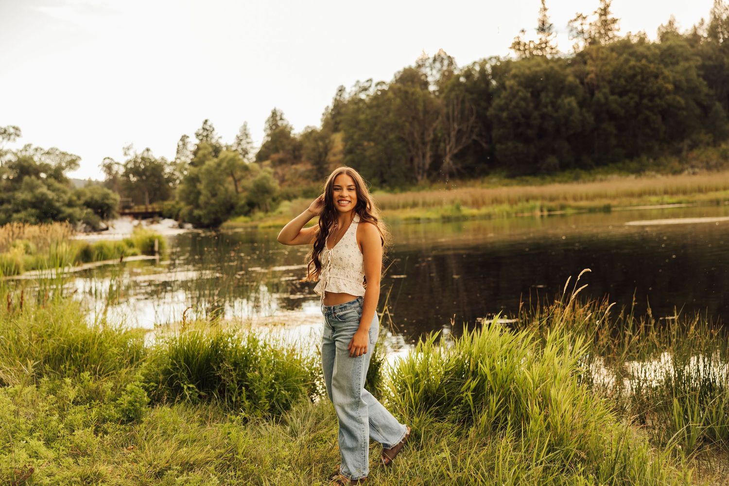 Candid moments captured along a lakeside trail during sunset with evergreen trees in view.
