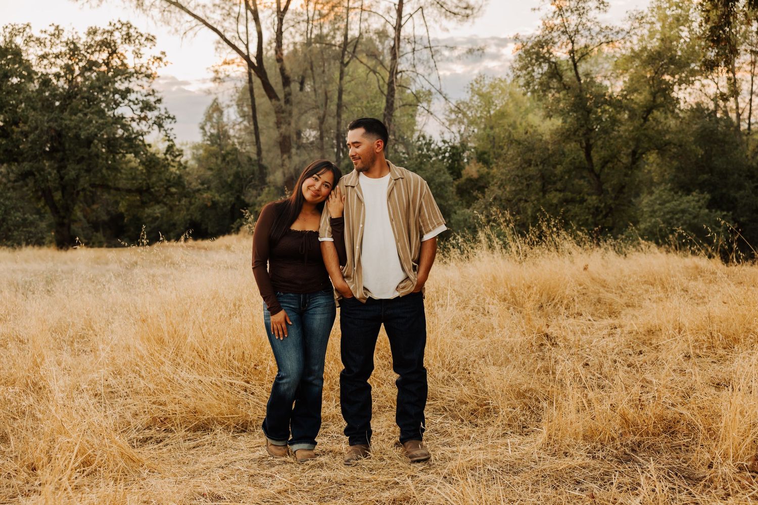 Family enjoying a casual stroll through a natural outdoor setting at golden hour.