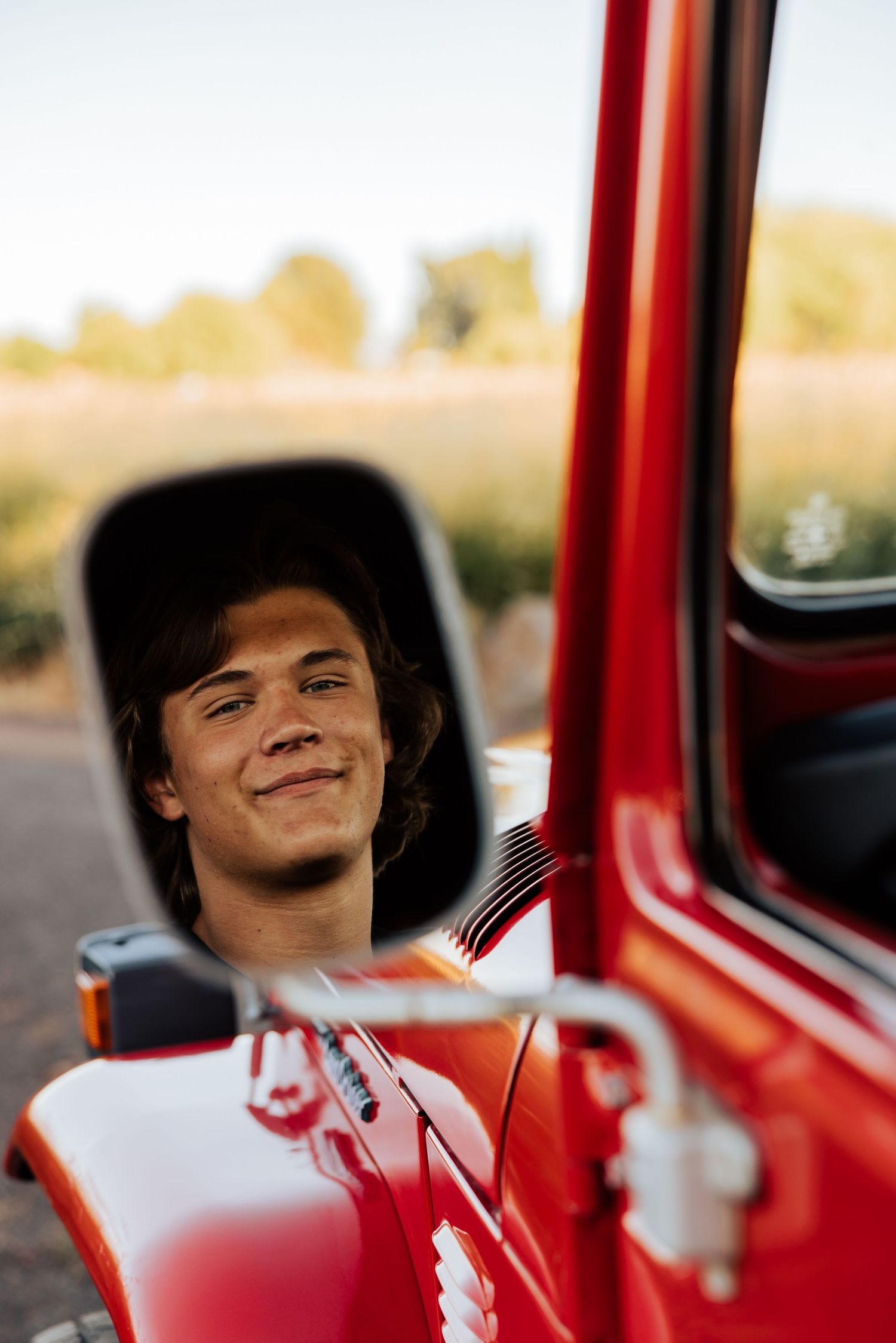 Person enjoying moment inside vintage red Toyota Land Cruiser.