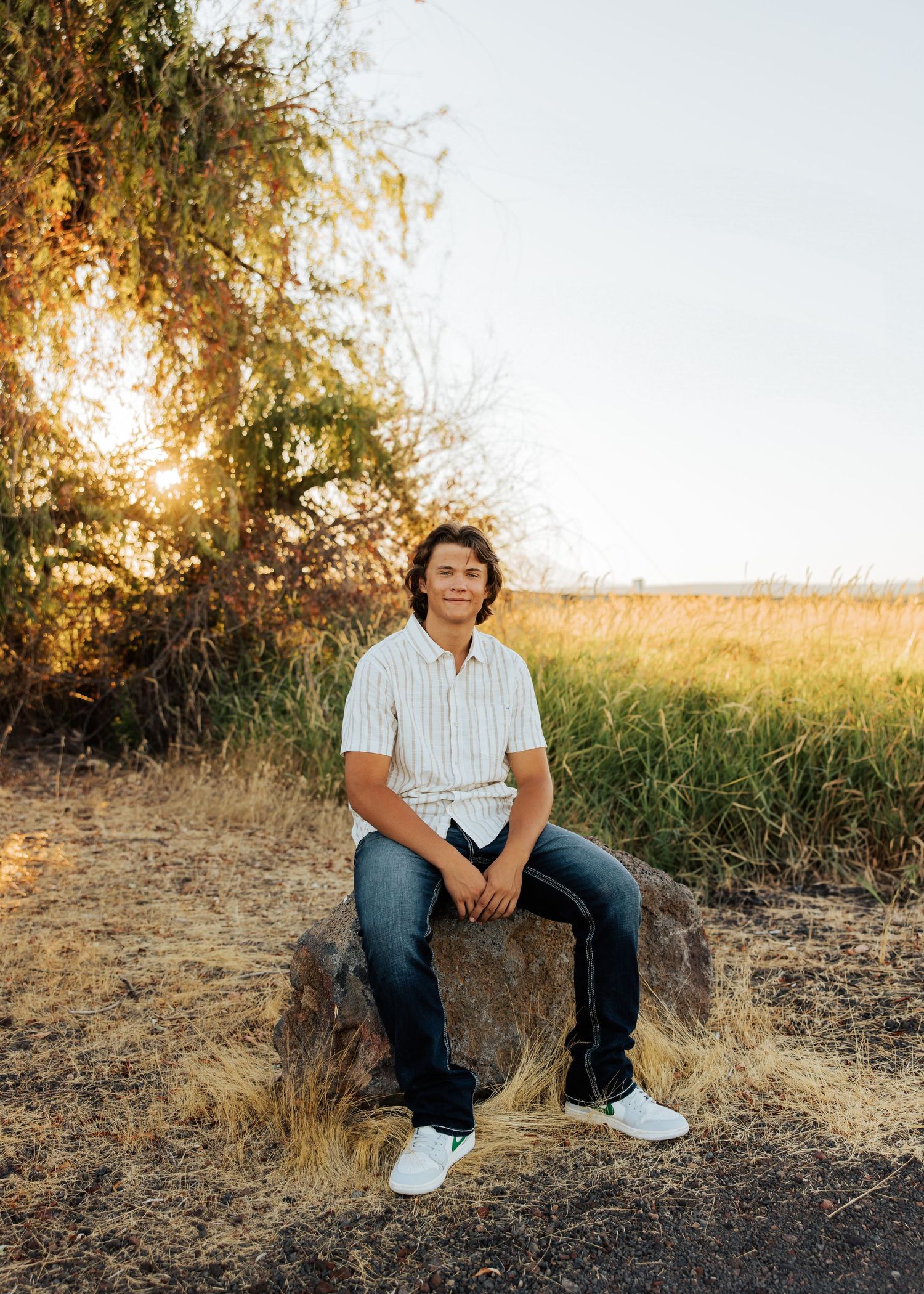 Natural outdoor portraits taken in a field with dry grass and trees during golden hour.