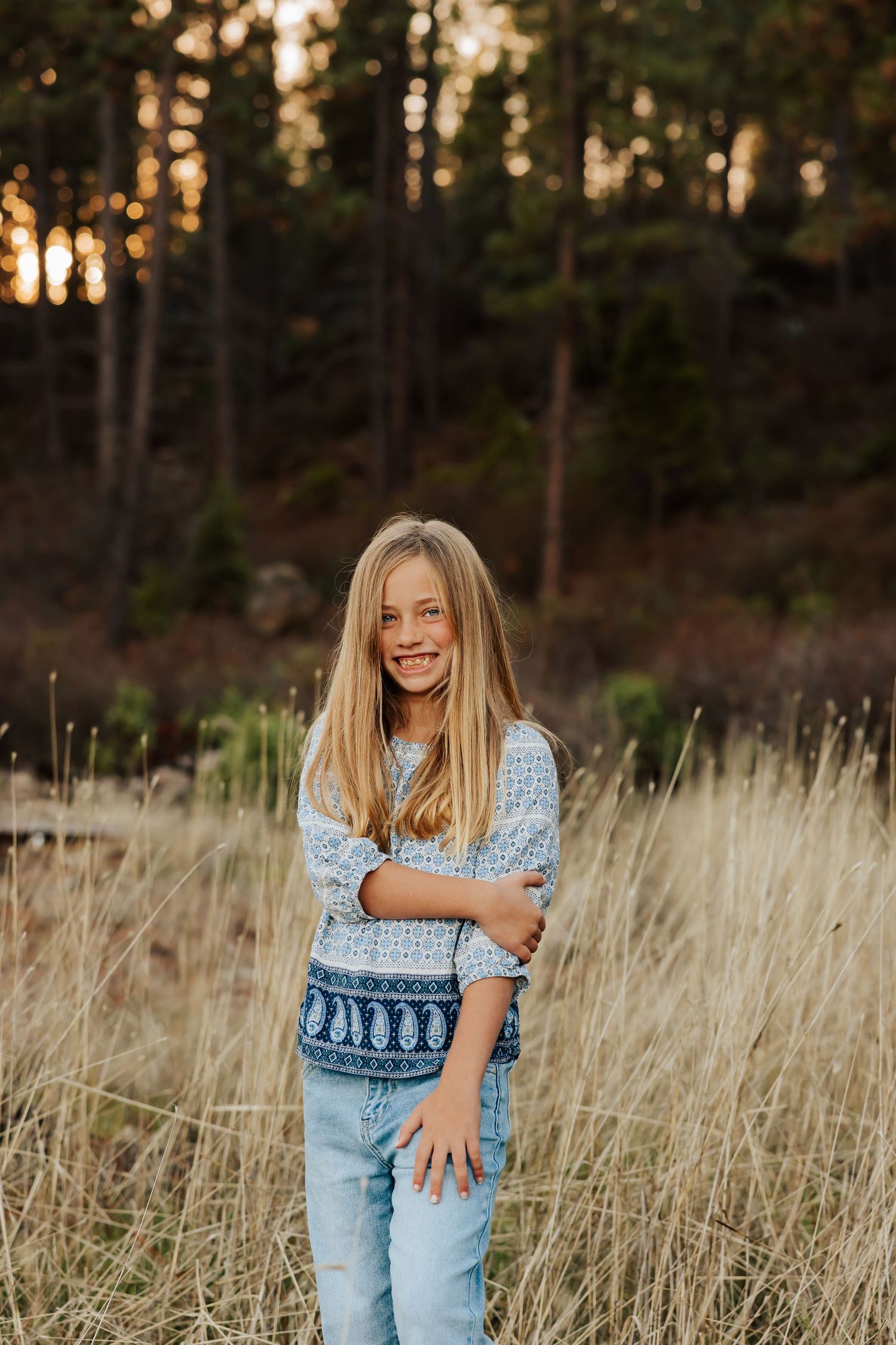 Candid lifestyle portraits in casual denim against natural grass field backdrop.