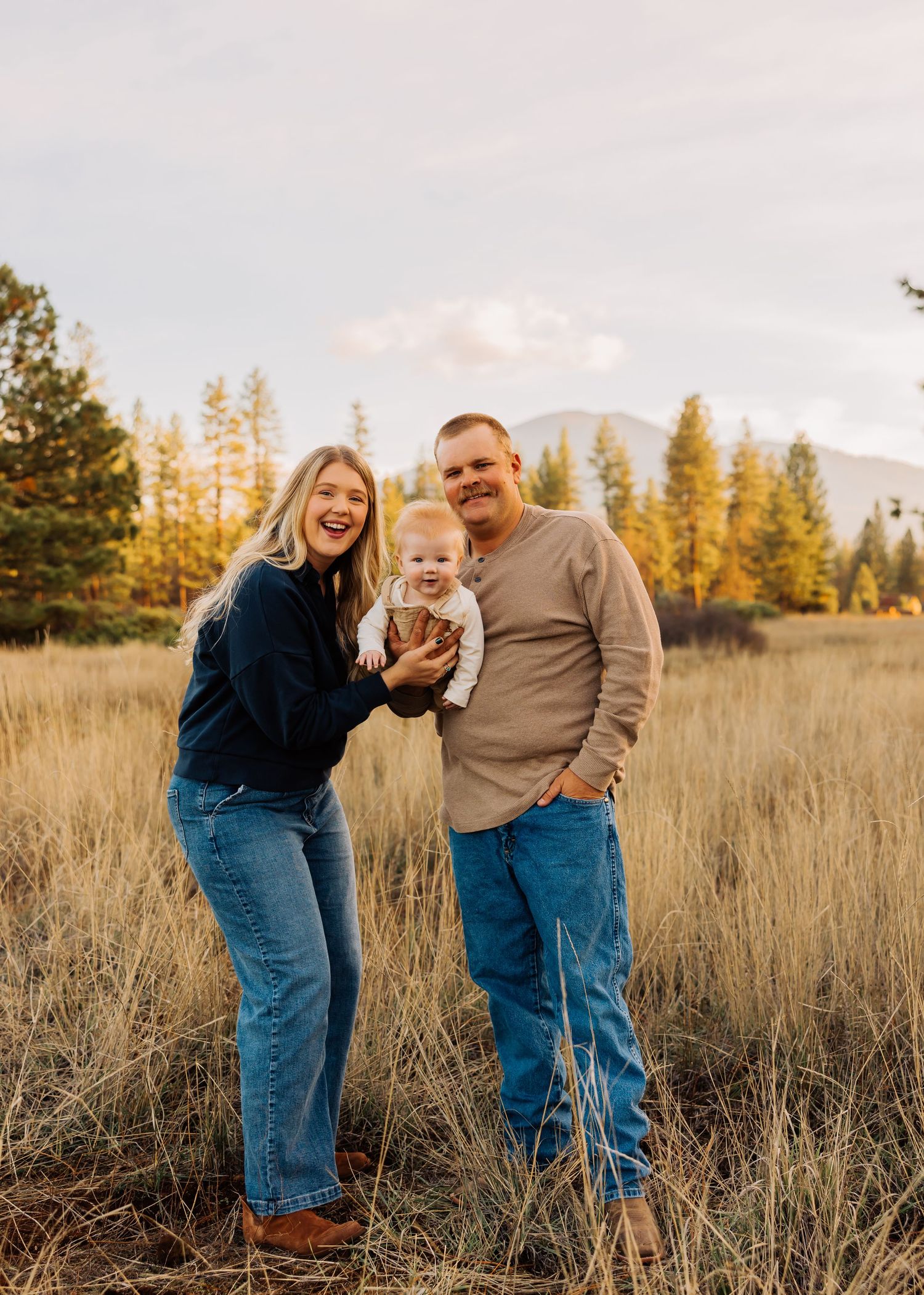 A family enjoys a warm autumn evening in a mountain meadow.