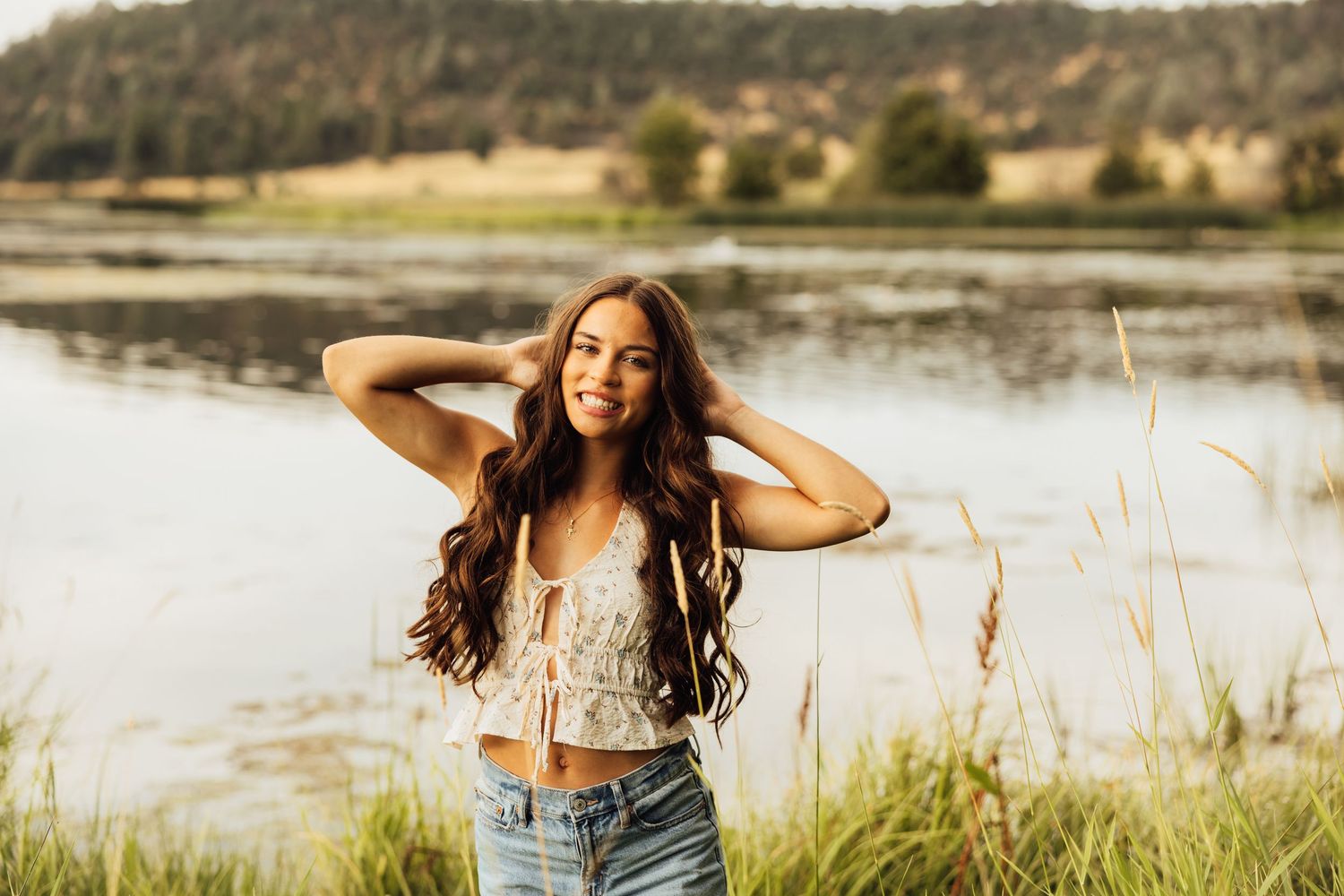 Outdoor photography session against a backdrop of mountains and a peaceful lake.