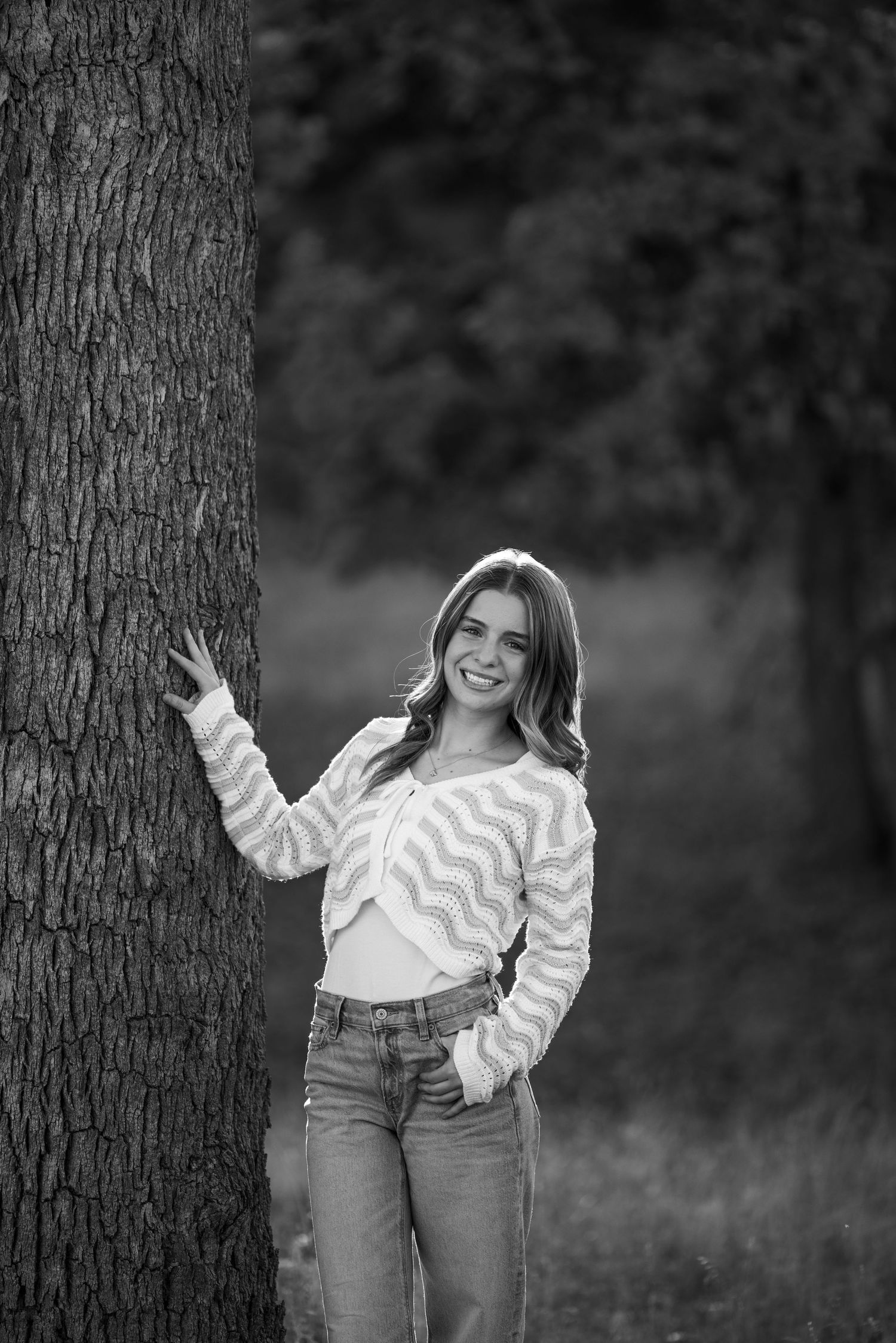 Playful black and white senior photos featuring striped top and casual poses.