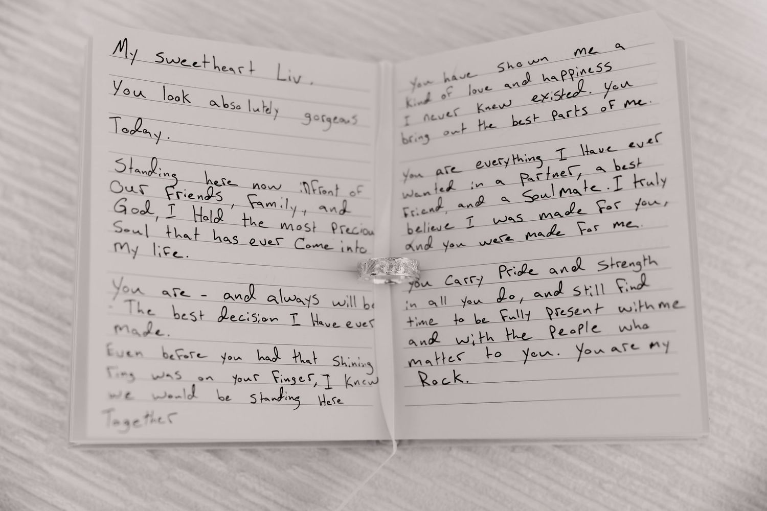 Handwritten love letter notes spread out on a white surface.